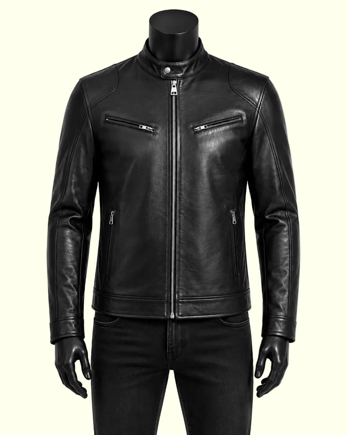 A black leather motorcycle jacket displayed on a black mannequin torso with black pants against a plain white background.