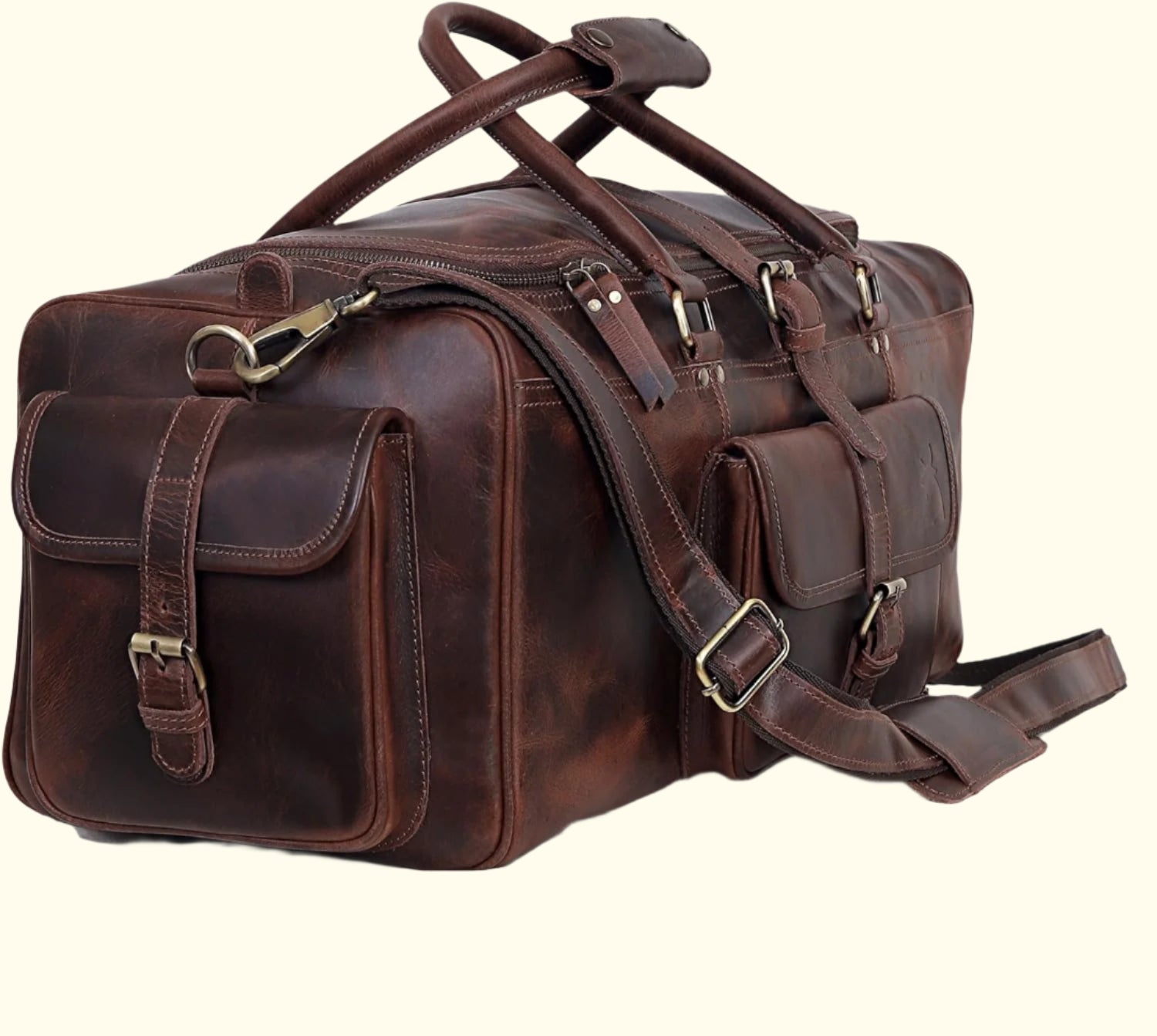 Brown leather duffel bag with multiple straps on a white background