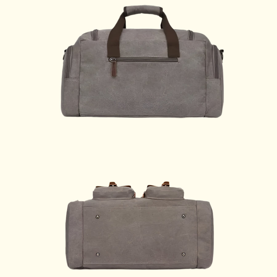 Gray duffel bag with brown handles and zippers on a white background