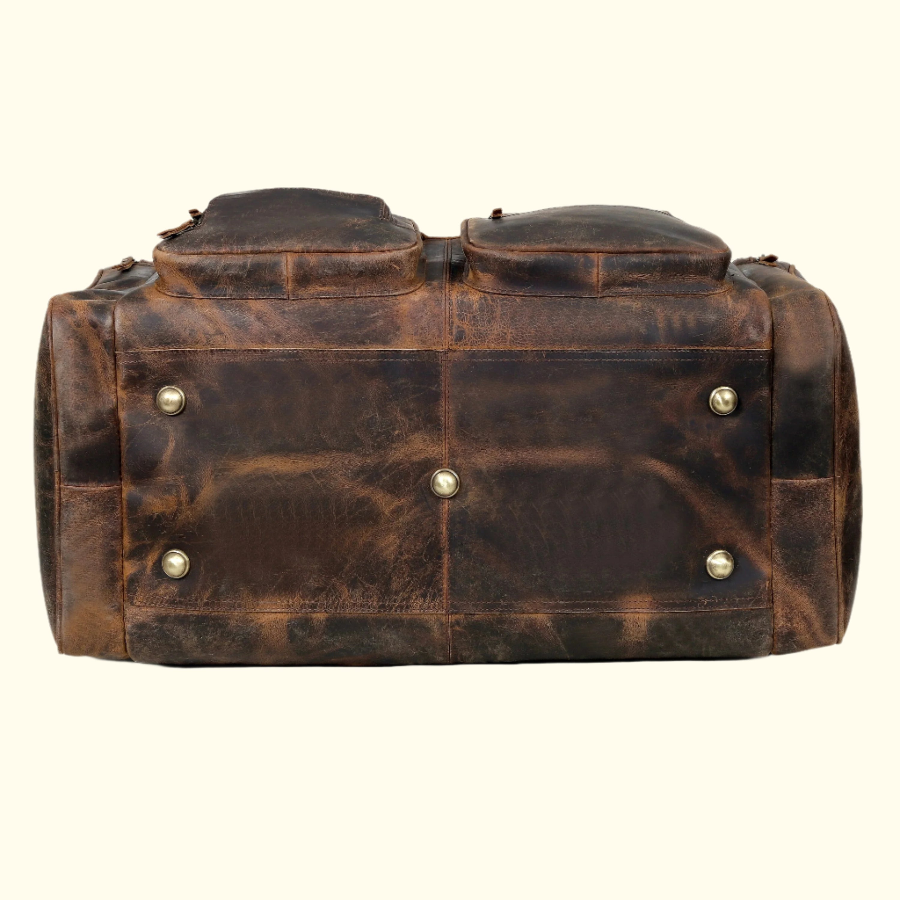 Brown leather duffel bag with gold rivets on a white background