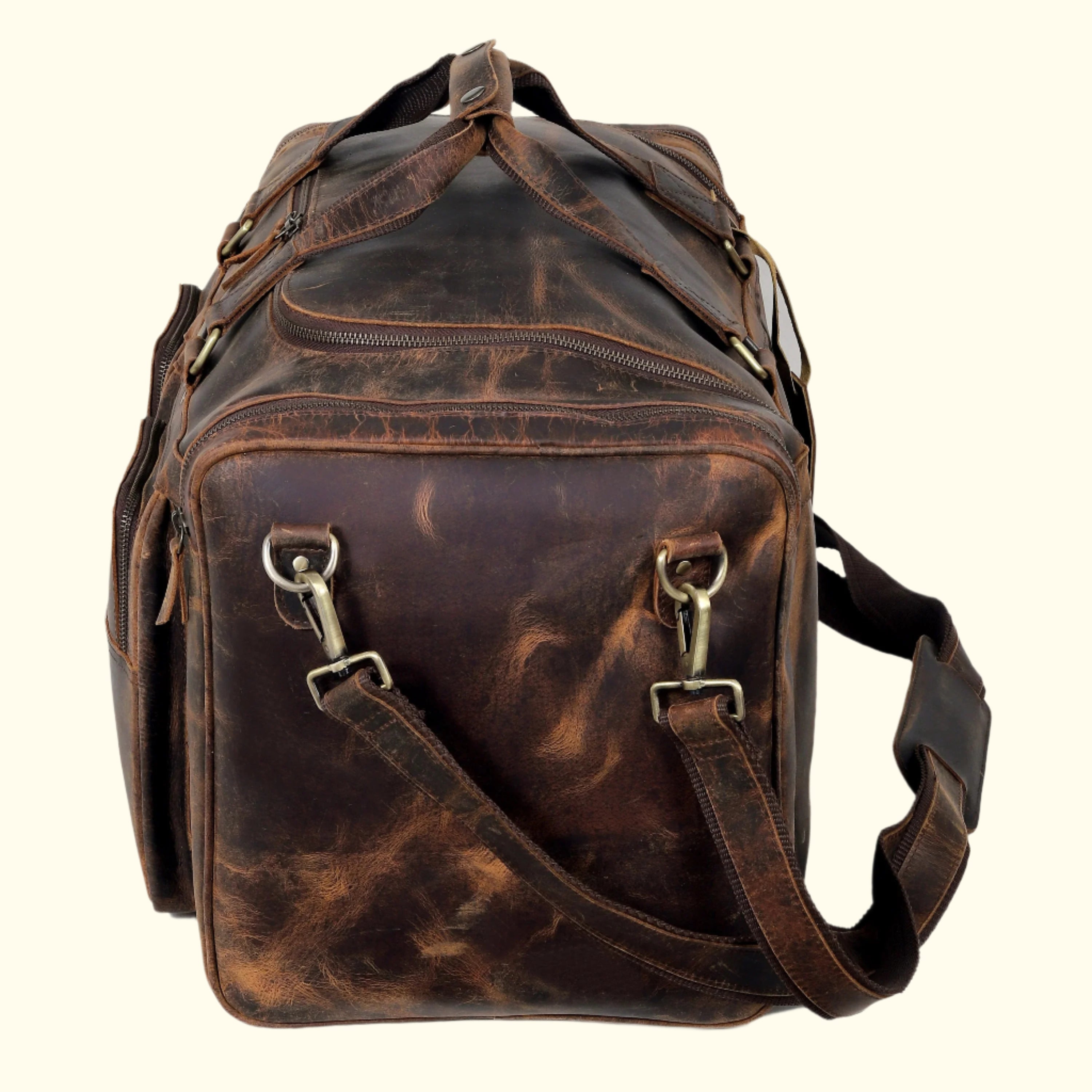 Brown leather bag with gold hardware on a white background