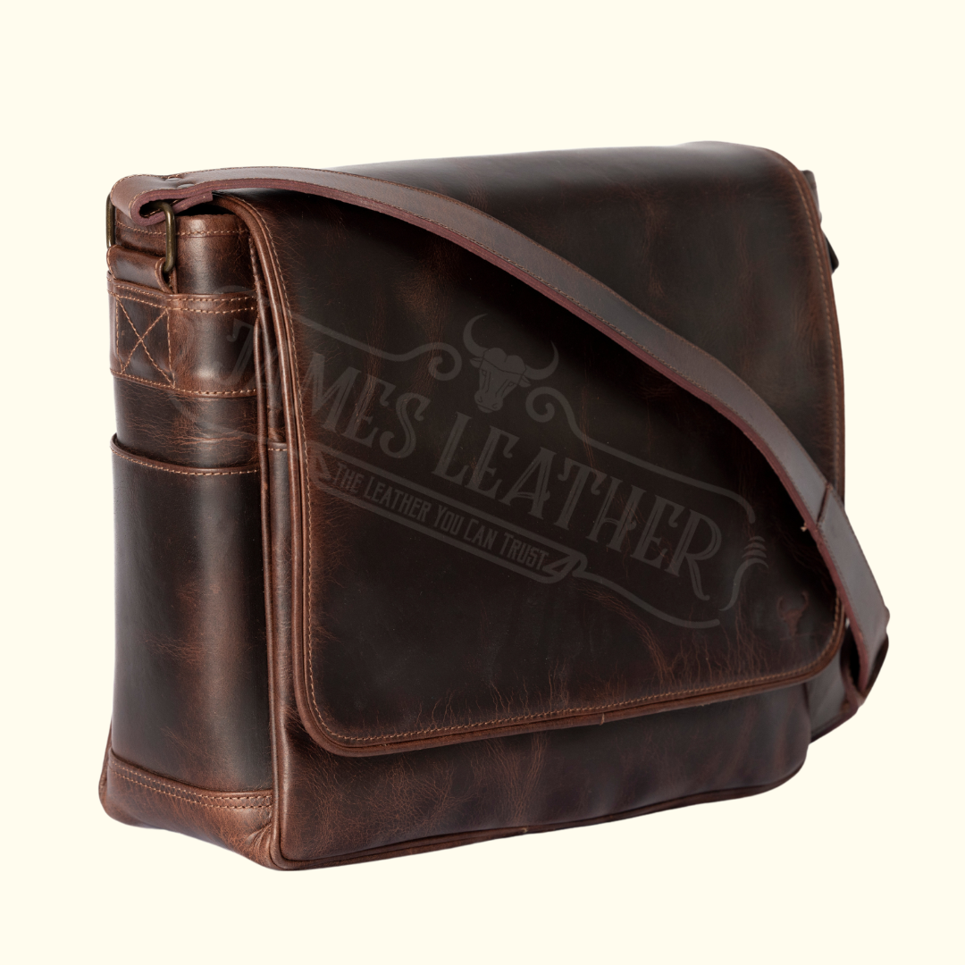 A brown full-grain buffalo leather messenger bag with an embossed logo on the side.