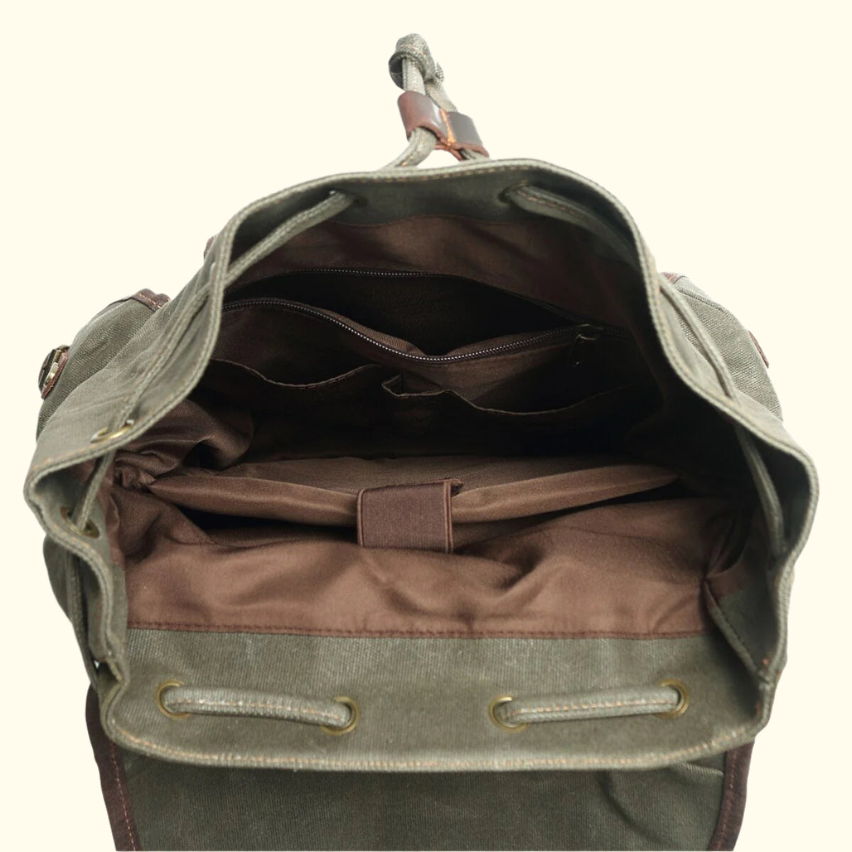 Open green backpack with brown interior on a white background