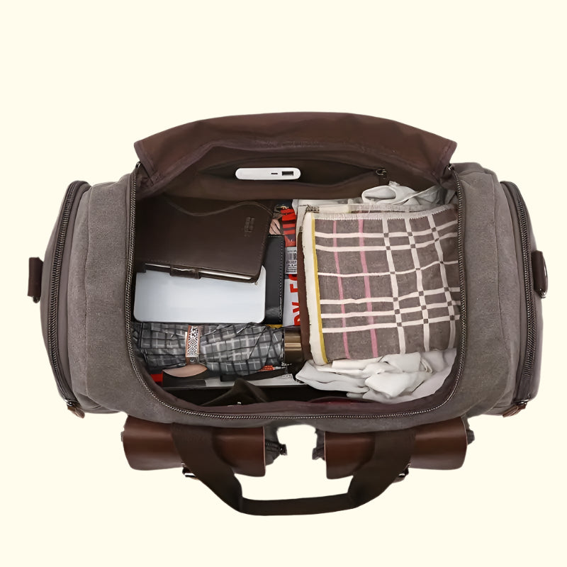 Open duffel bag with various items on a white background