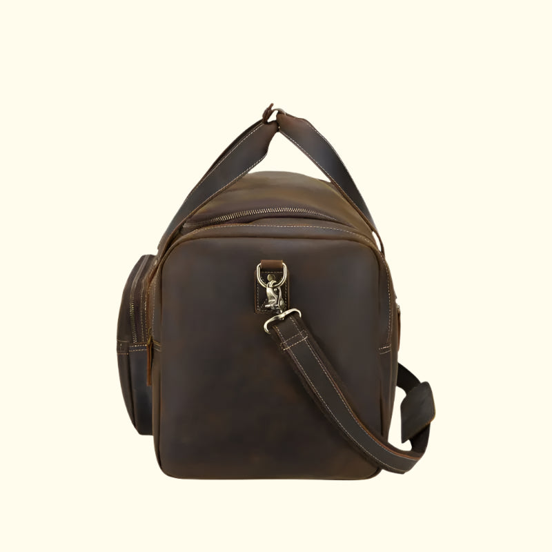 Brown leather duffel bag with shoulder strap on a white background