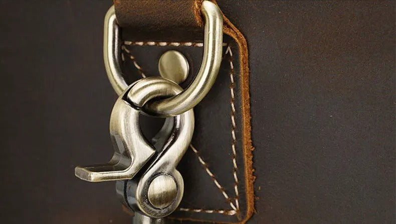Close-up of a leather bag with a metal clasp on a dark background