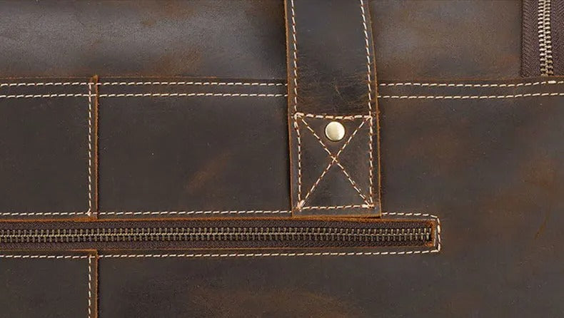 Close-up of a brown leather bag with visible stitching