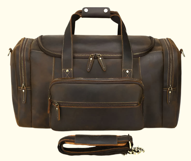 Brown leather duffel bag with shoulder strap on a white background